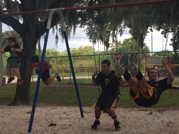 two Pirates baseball players on swing set